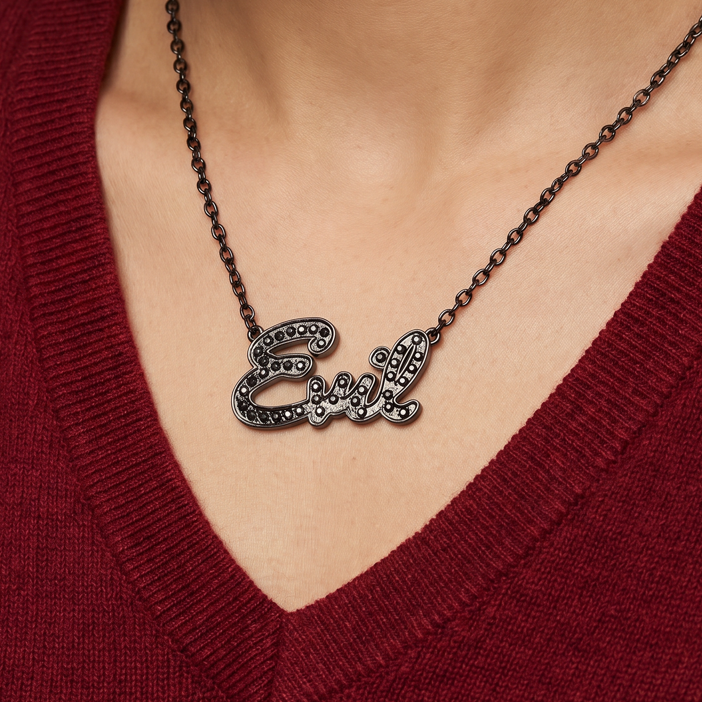 Necklace with 'Girl' pendant worn by a person in a red sweater