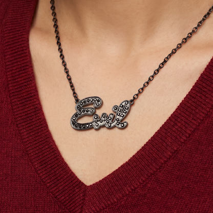 Necklace with 'Girl' pendant worn by a person in a red sweater