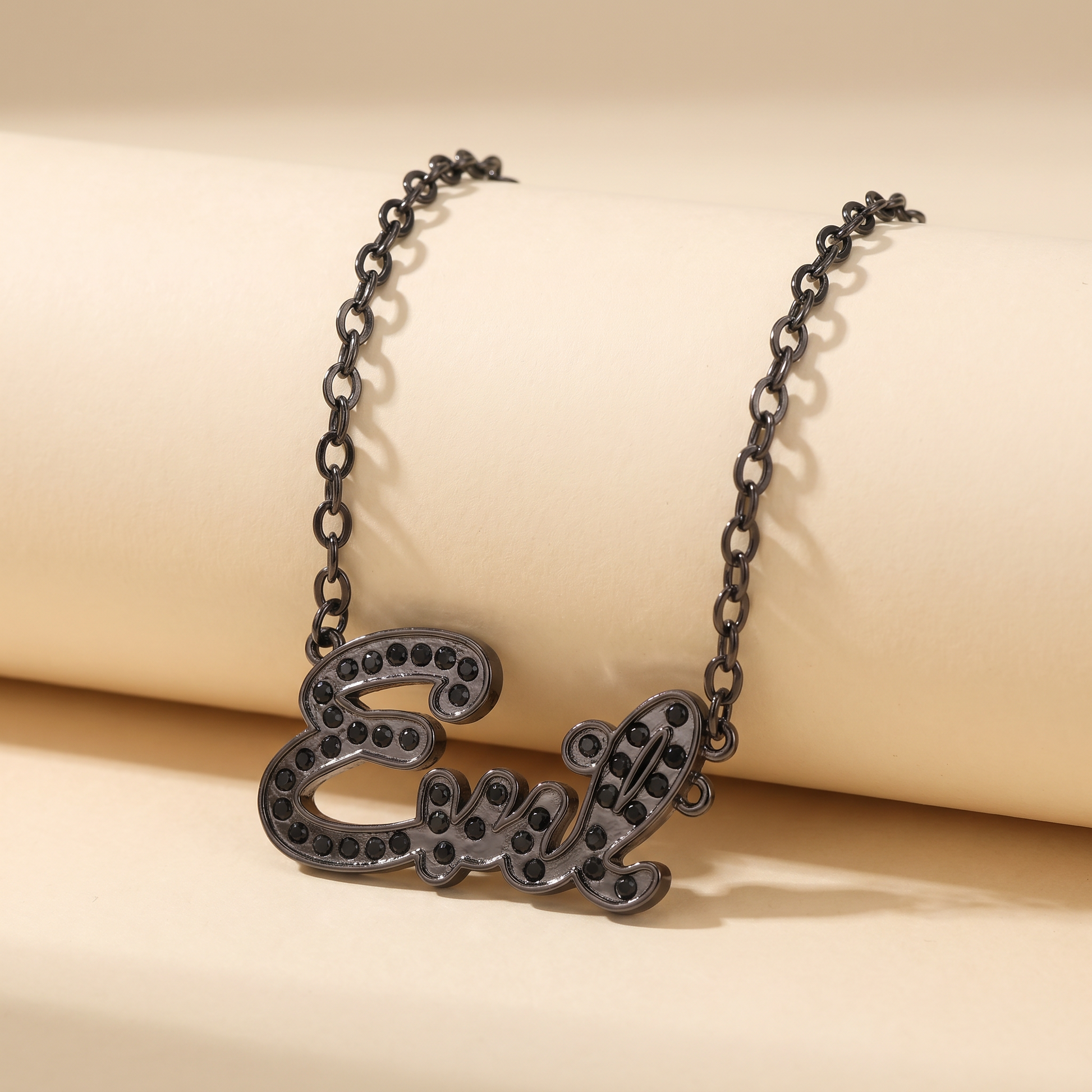Necklace with 'Eve' pendant on a beige background