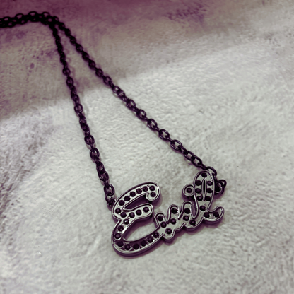 Necklace with 'Evel' pendant on a textured surface