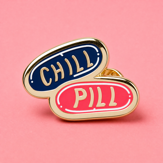 Double-sided enamel pin with 'CHILL' on one side and 'PILL' on the other, on a pink background.