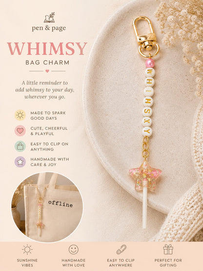 Bag charm with beads and gold accents on a plate and letter beads spelling whimsey with a star shaped lollipop charm, featuring 'pen & page' branding.