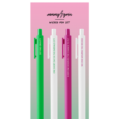 A set of four pens from the Sammy Borin Wicked Pen Set, displayed vertically on a pink and green gradient card. The pens are in green, white, and pink, each featuring vertical motivational text on their barrels.