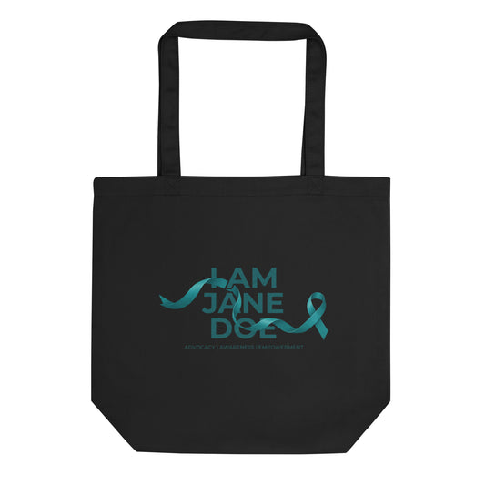 A black canvas tote bag with two black handles, featuring a teal graphic on the front that reads 'I AM JANE DOE' with a teal ribbon and the subtitle 'ADVOCACY | AWARENESS | EMPOWERMENT'.