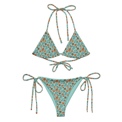 Showgirl Era String Bikini by Spinsterly Co in teal with all-over guitar and shell print, string ties