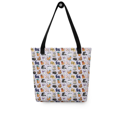 A tote bag with a white background and an all-over repeating pattern of small illustrated cats in various colors. The bag has black shoulder straps and is photographed against a plain white background.