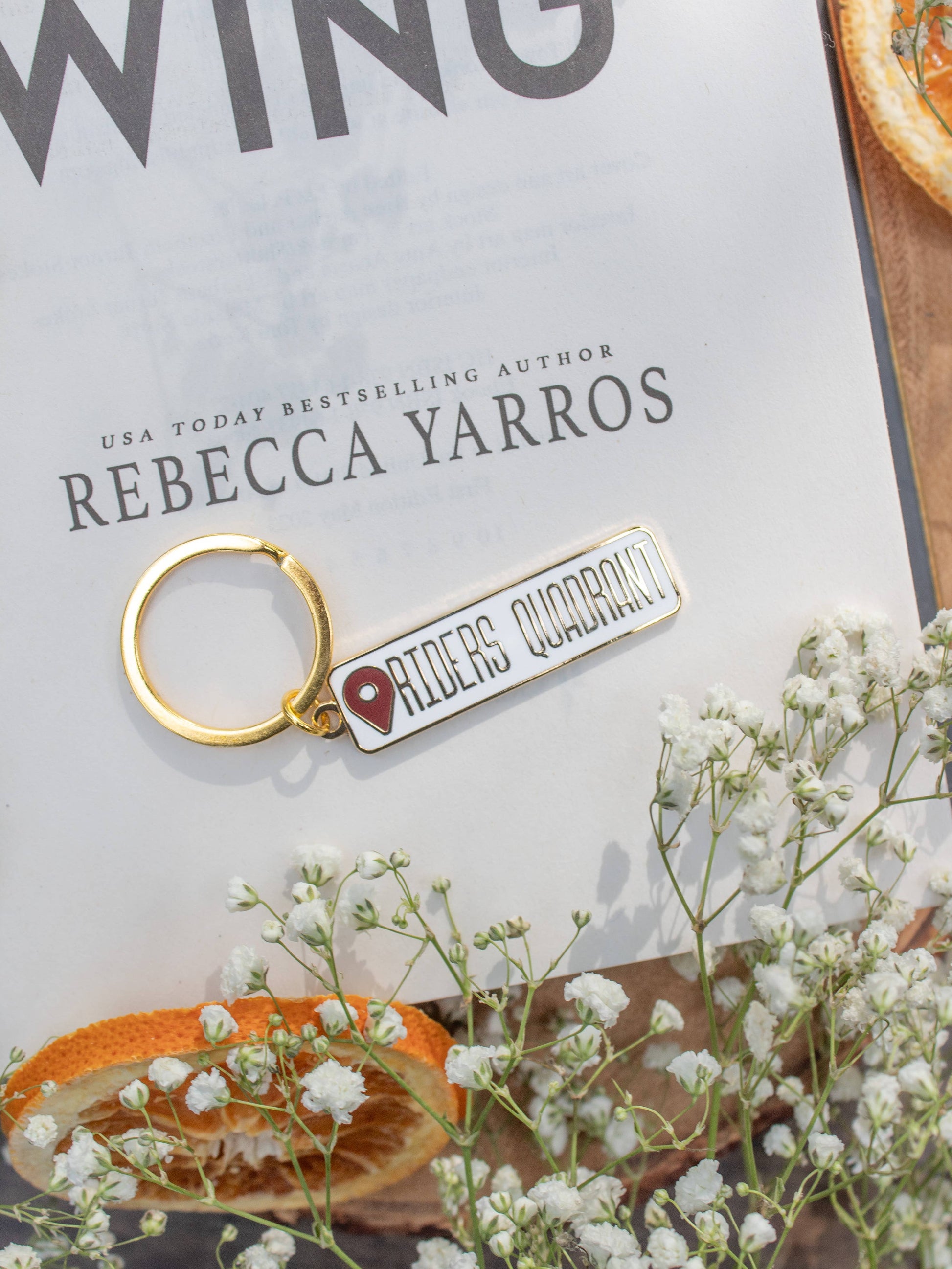 Riders Quadrant Location Keychain hard enamel by Meaggie Moos with gold metal accents and red enamel charm