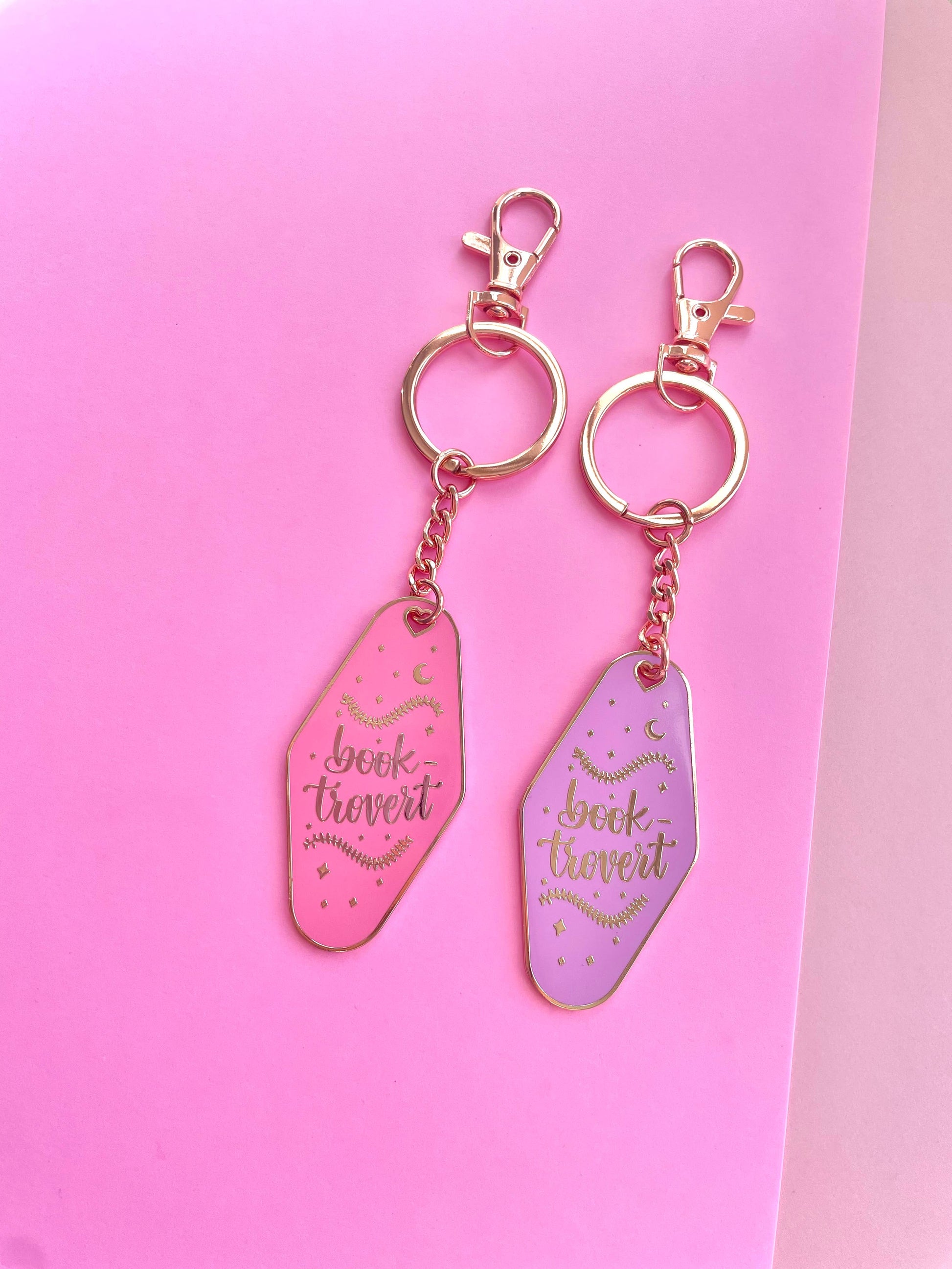 Booktrovert Hotel Keychain by Galloree Designs LLC in Pink metal with clip attachment and retro bookish fob