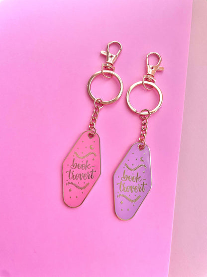 Booktrovert Hotel Keychain by Galloree Designs LLC in Pink metal with clip attachment and retro bookish fob