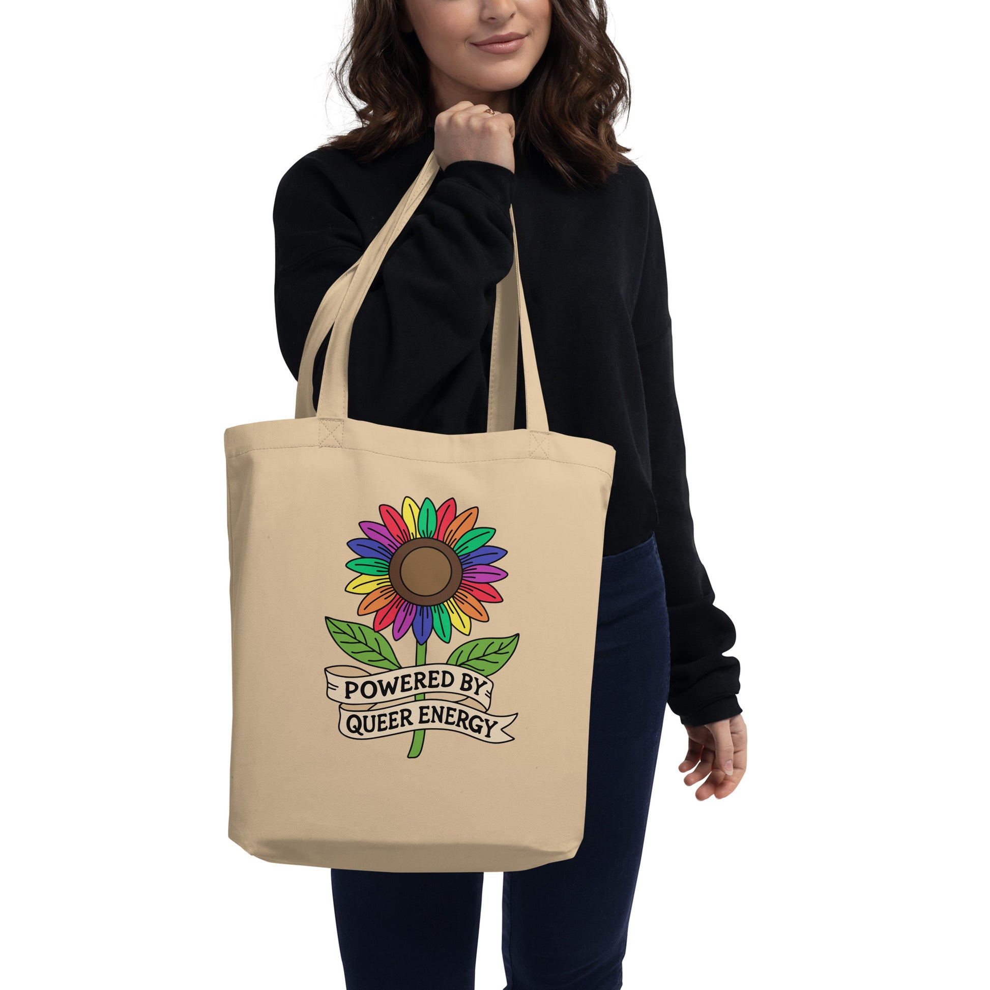 Powered by Queer Energy Eco Tote Bag Rainbow Sunflower LGBTQIA Tote by Spinsterly Co in beige with ribbon banner graphic