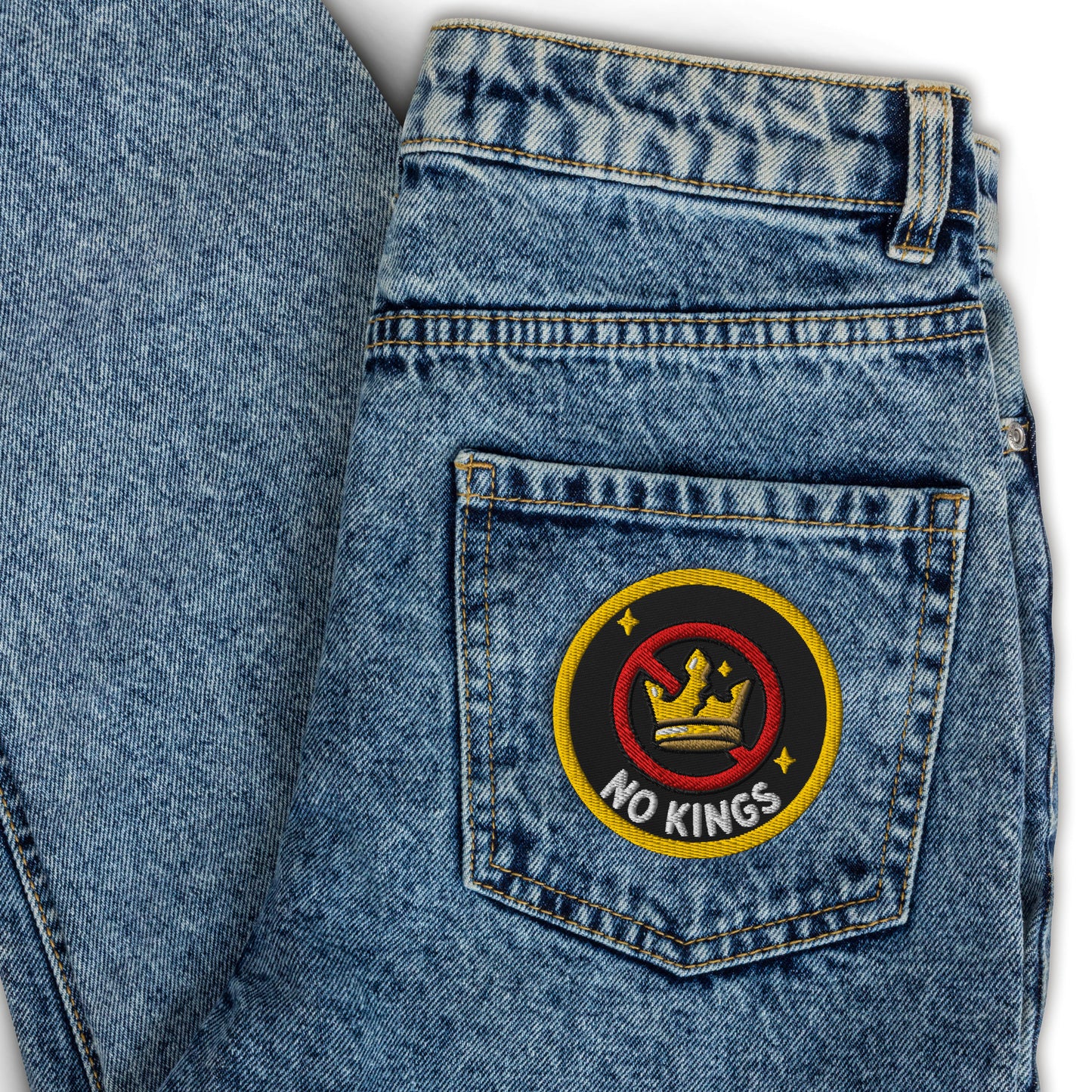 No Kings Embroidered Iron-On Patch by Spinsterly Co, black and yellow crossed-out crown design on denim