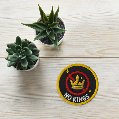No Kings Embroidered Iron-On Patch by Spinsterly Co, black and yellow crossed out crown design
