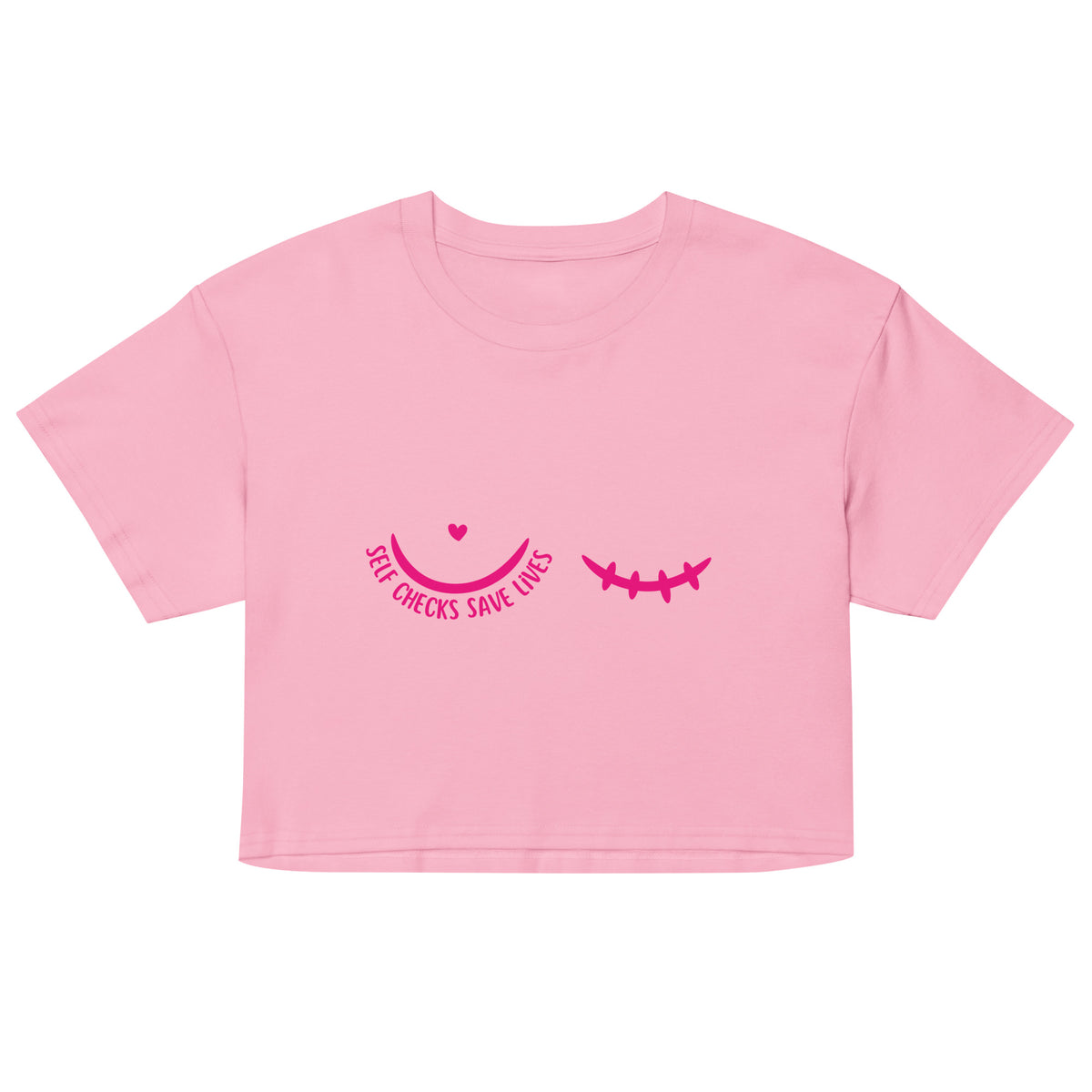 A pink short-sleeve crop top t-shirt featuring a dark pink graphic on the chest with a pair of half circles, one with a small heart and text 'Self checks save lives' and the other with mastectomy stitches.