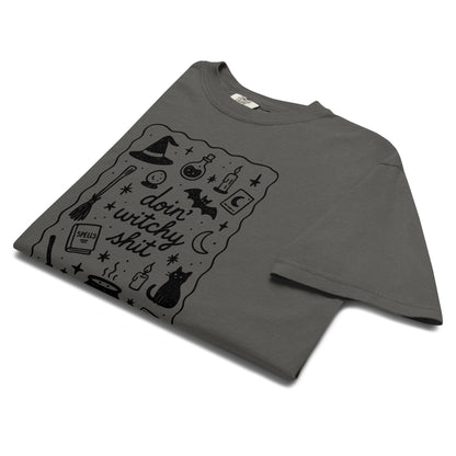 Folded product mockup of a grey comfort colors t-shirt with a witchy inspired graphic for Halloween