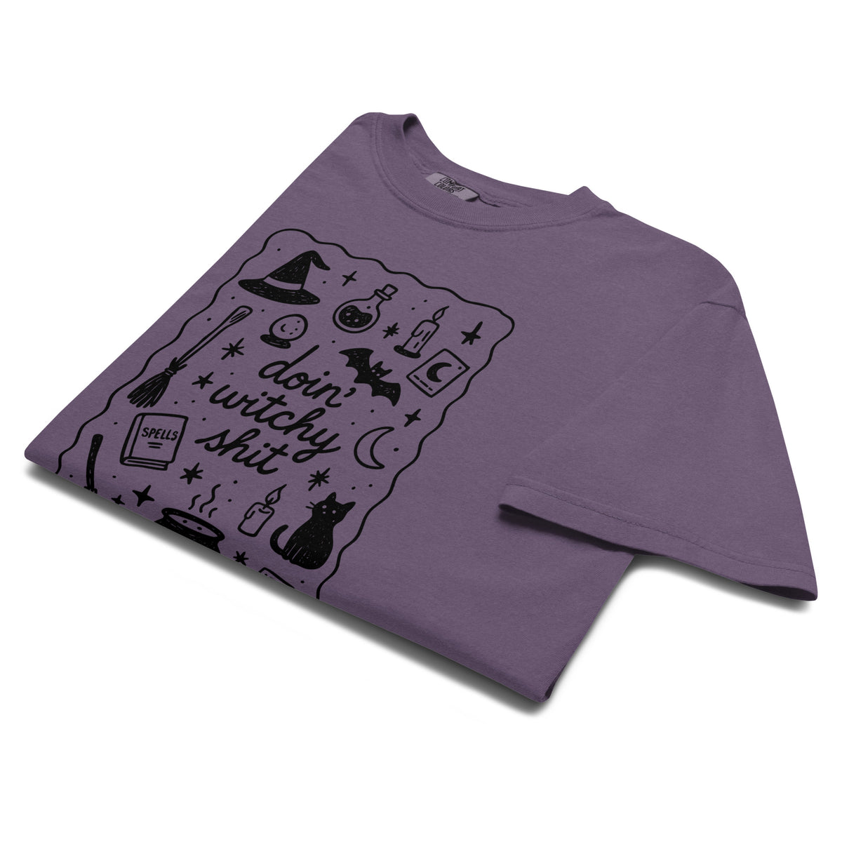 Folded product mockup of a purple comfort colors t-shirt with a witchy inspired graphic for Halloween