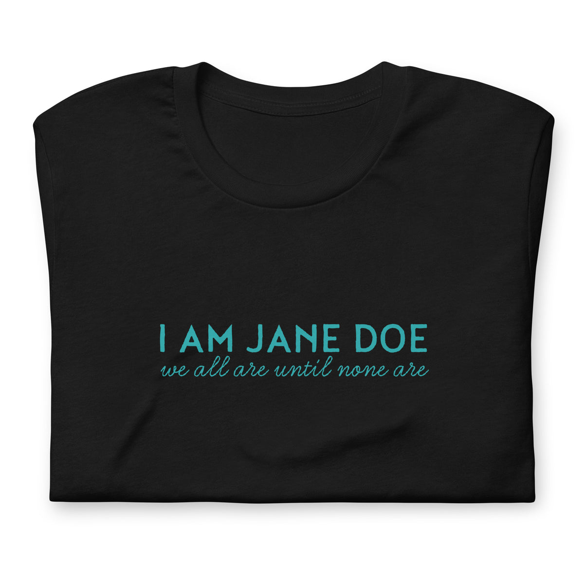 A folded black t-shirt with a teal graphic print on the front reading 'I AM JANE DOE' and 'we all are until none are', shown on a plain white background.