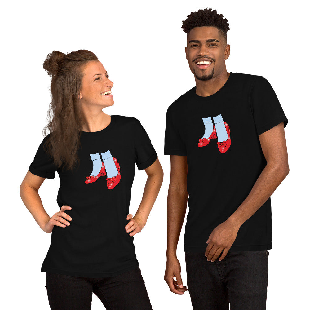 A man and woman wearing black Friends of Dorothy pride t-shirts with the ruby-slipper design.