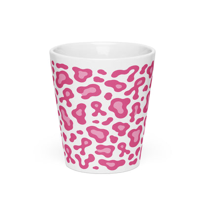 A white ceramic shot glass featuring a pink leopard print pattern, shown against a plain white background.