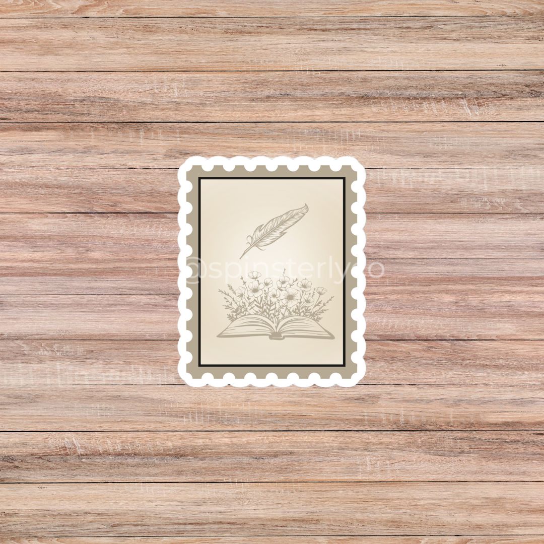 A rectangular vintage-style art print with a scalloped white border, featuring a beige illustration of an open book and feather quill on a wood plank background.