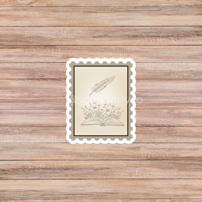 A rectangular vintage-style art print with a scalloped white border, featuring a beige illustration of an open book and feather quill on a wood plank background.