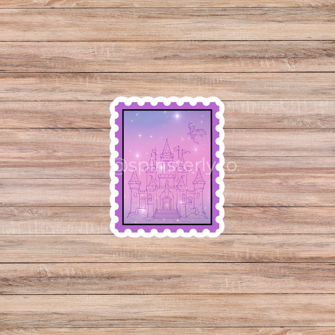 A rectangular die-cut sticker with a purple border and a pink-lavender castle illustration, placed on a light brown wood plank background.