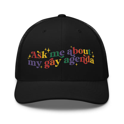 Ask Me About My Gay Agenda Trucker Hat by Spinsterly Co in black with embroidered text graphic