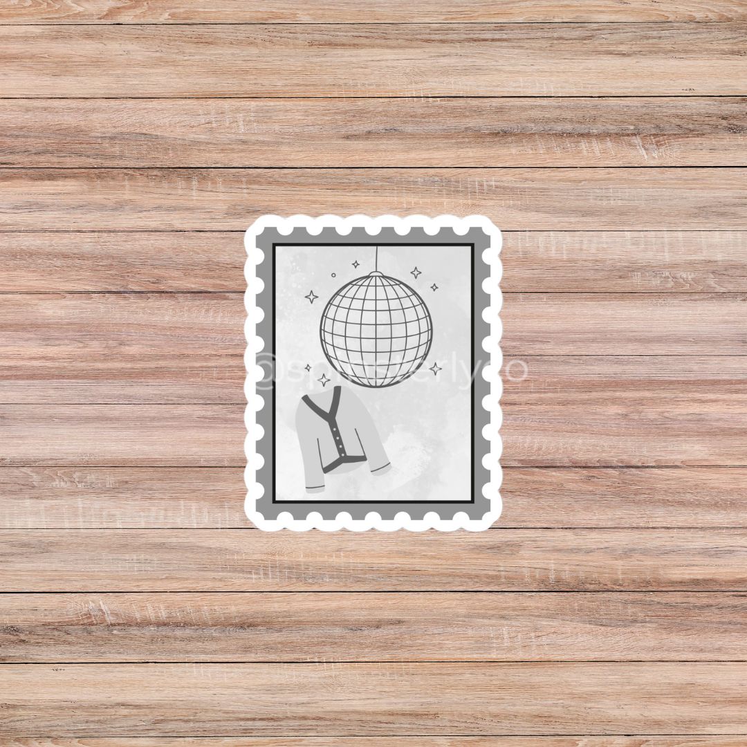 A rectangular scalloped sticker or label with a black-and-white disco ball and tie illustration, placed on a light brown wood plank background.