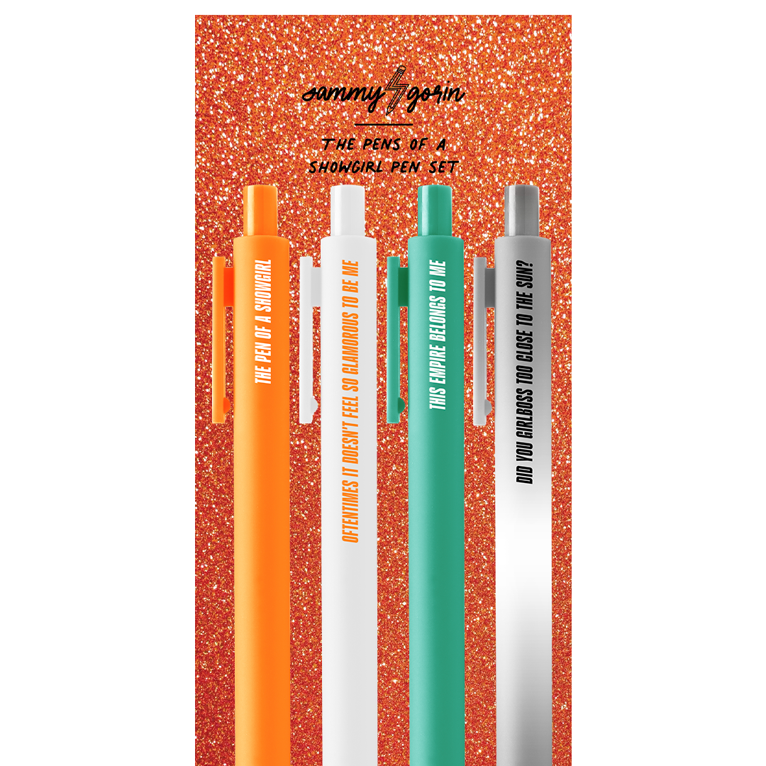 Set of four pens with orange, white, green, and gray colors on a glittery red background.