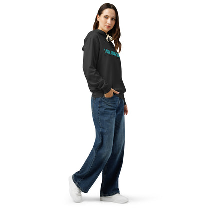 Person wearing a black hoodie with white text and blue jeans on a white background