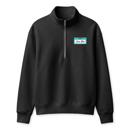 A black long-sleeve quarter-zip sweatshirt with a mock neck collar, featuring a small teal and white 'Hello My Name is Jane Doe' name-tag graphic on the left chest, displayed on a clean white background.