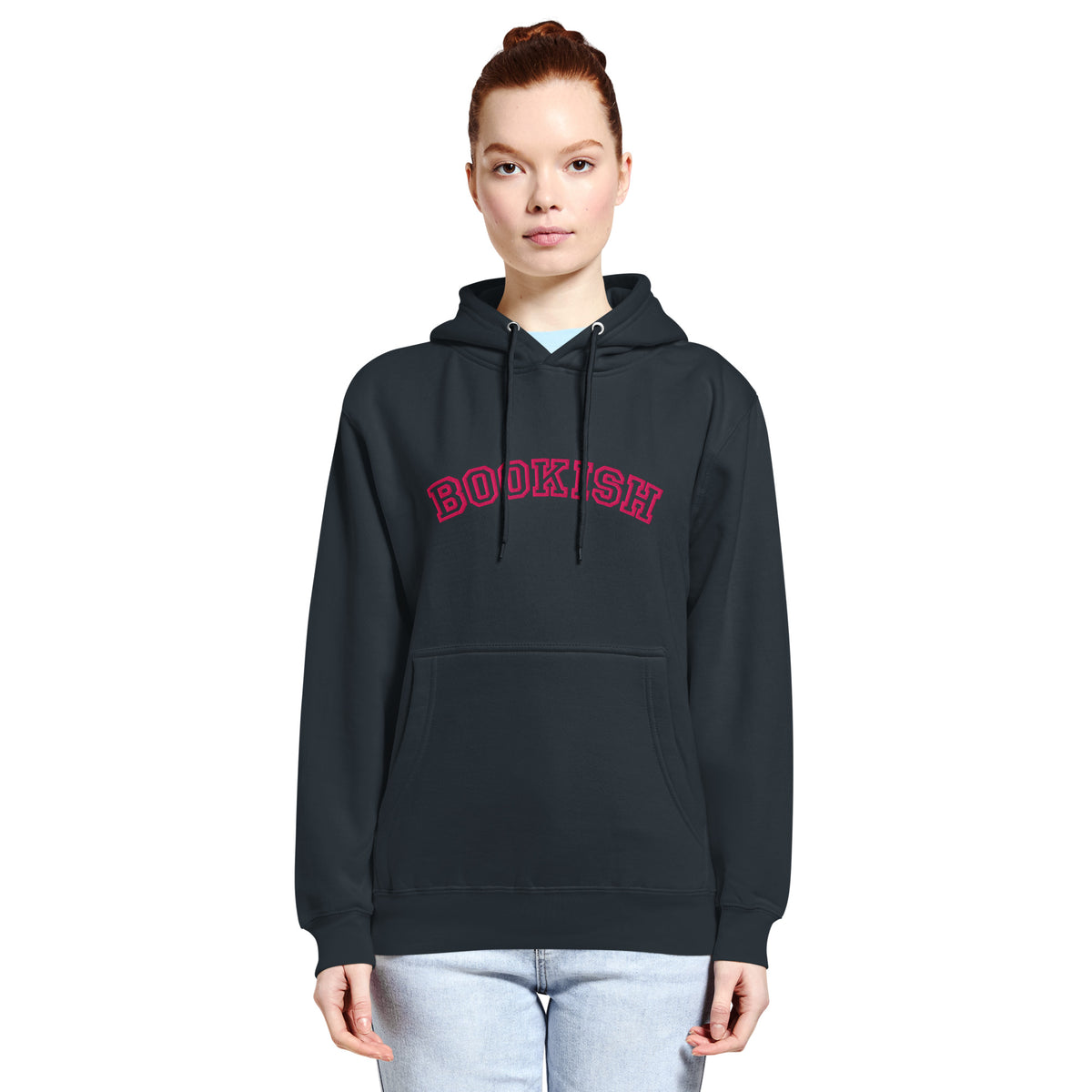 Person wearing a navy-blue hoodie with a pink embriderly that reads 'BOOKISH' in university style font on a white background
