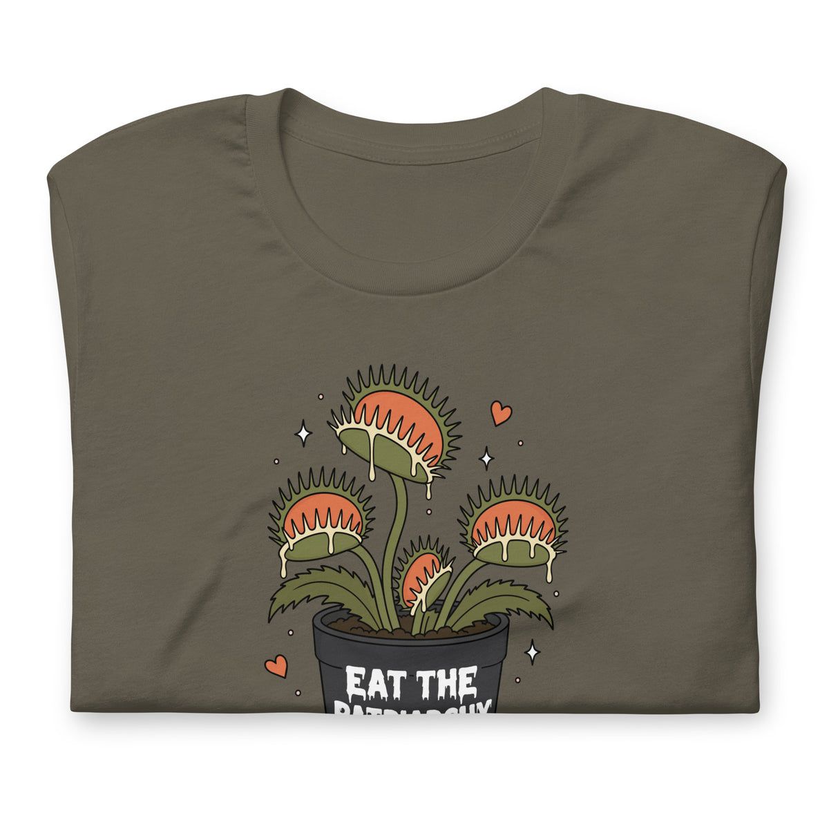 A folded dark olive green t-shirt featuring a cartoon graphic of a potted Venus flytrap with the text 'EAT THE PATRIARCHY' on the front, set against a plain white background.