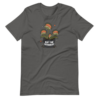 A dark gray short-sleeve t-shirt with a graphic of three carnivorous Venus flytraps in a pot with the text 'EAT THE PATRIARCHY' written below, displayed on a solid white background.