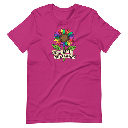A bright pink short-sleeve t-shirt with a colorful rainbow sunflower graphic and a banner reading 'POWERED BY QUEER ENERGY' on the chest, shown against a plain white background.