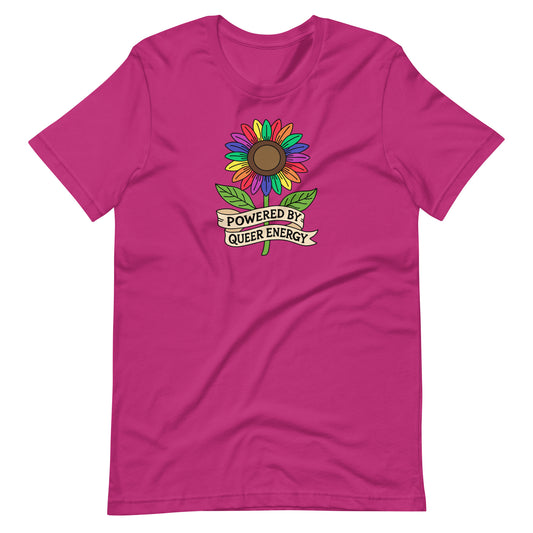 A bright pink short-sleeve t-shirt with a colorful rainbow sunflower graphic and a banner reading 'POWERED BY QUEER ENERGY' on the chest, shown against a plain white background.
