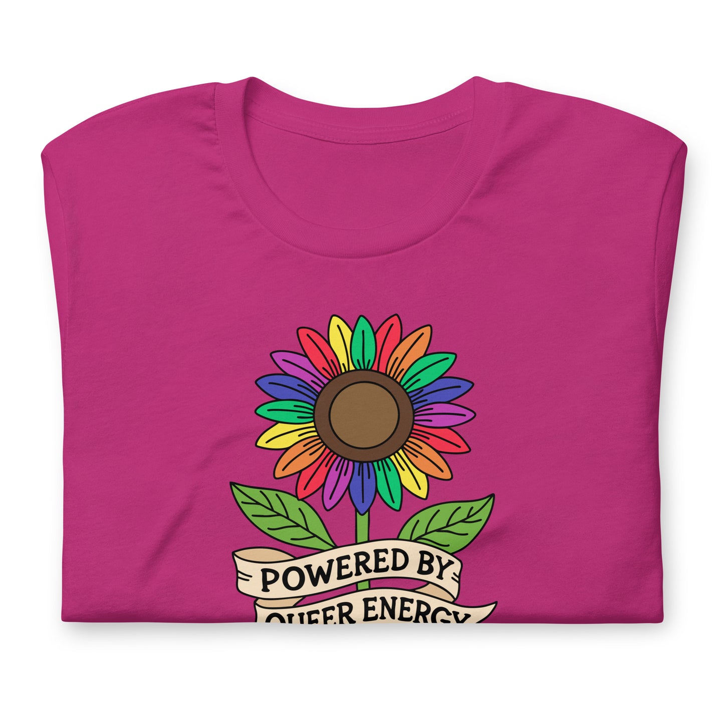 A folded magenta pink t-shirt featuring a colorful rainbow sunflower graphic with green leaves and a banner that reads 'POWERED BY QUEER ENERGY'.