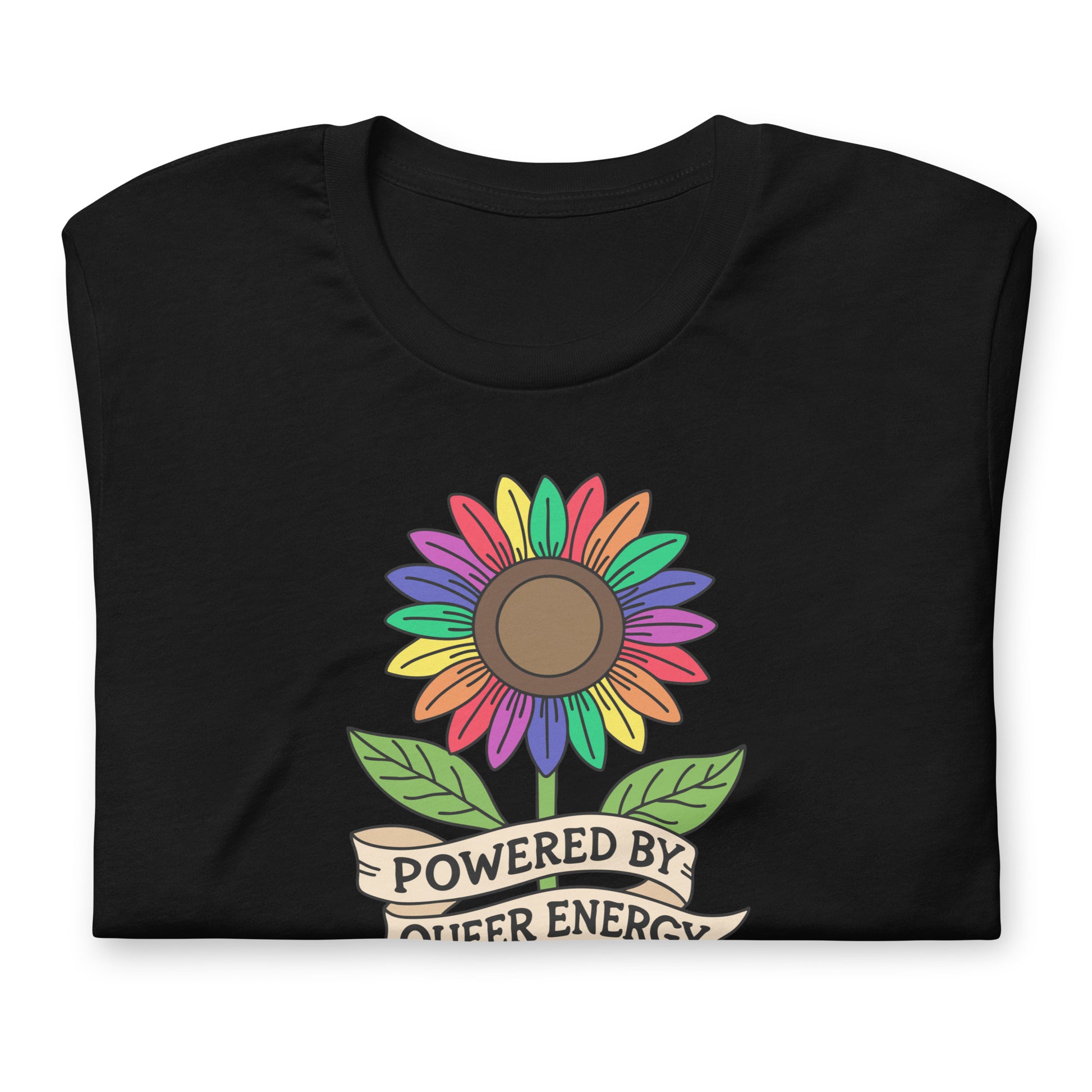 A black folded t-shirt featuring a colorful rainbow sunflower graphic with green leaves and a banner that reads 'POWERED BY QUEER ENERGY'.