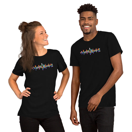 A smiling woman and man standing together, both wearing black t-shirts with a colorful Pride heart graphic on the chest.