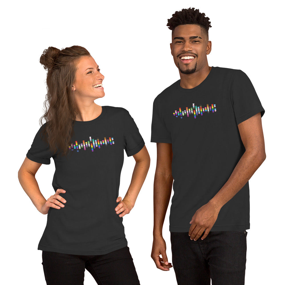 A smiling woman and man standing together, both wearing grey t-shirts with a colorful Pride heart graphic on the chest.