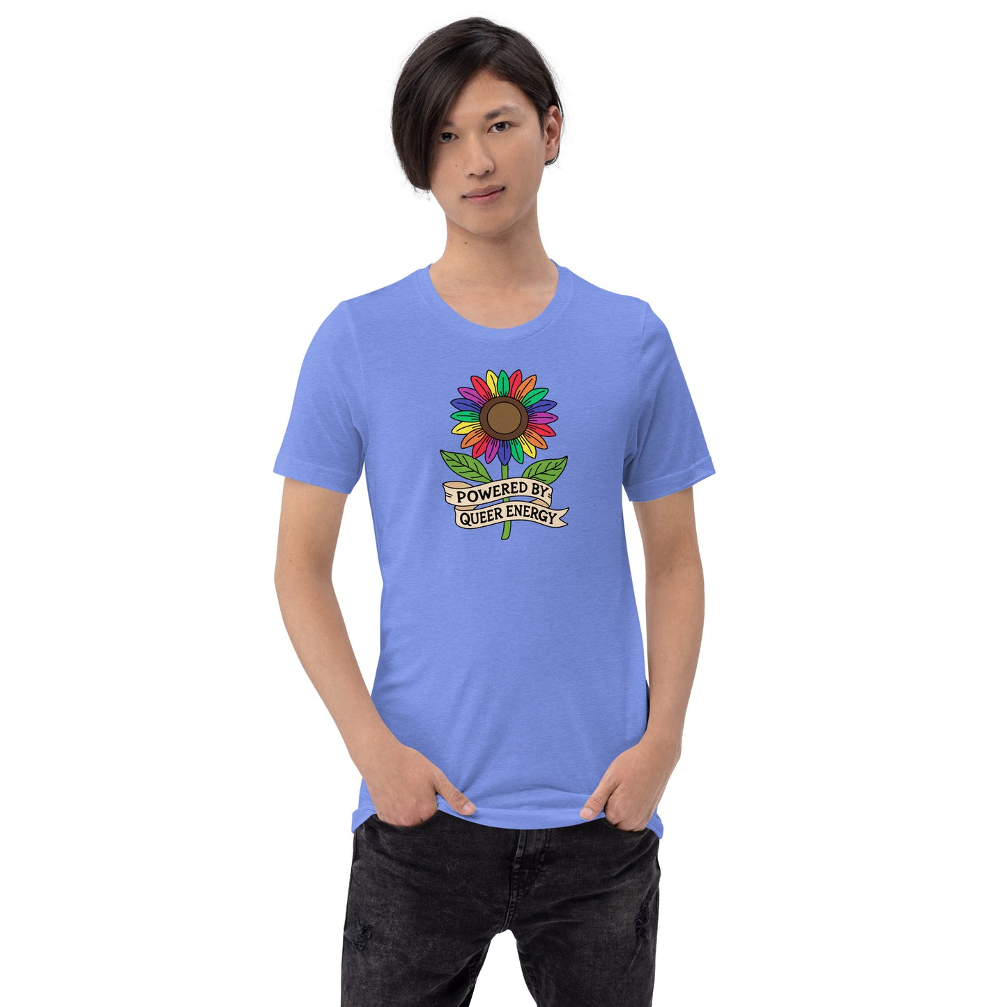 A model wearing a light blue crewneck t-shirt with a colorful rainbow sunflower graphic and the text 'POWERED BY QUEER ENERGY' on the chest, paired with black jeans against a plain white background.
