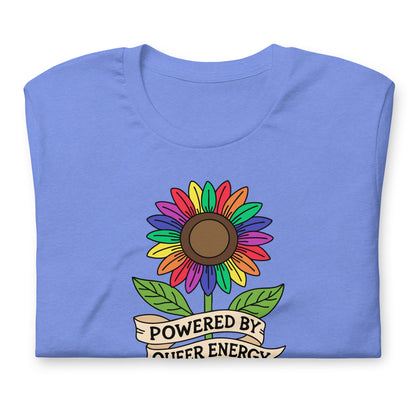 A folded light blue t-shirt with a colorful rainbow sunflower graphic and a banner underneath that reads 'POWERED BY QUEER ENERGY'.