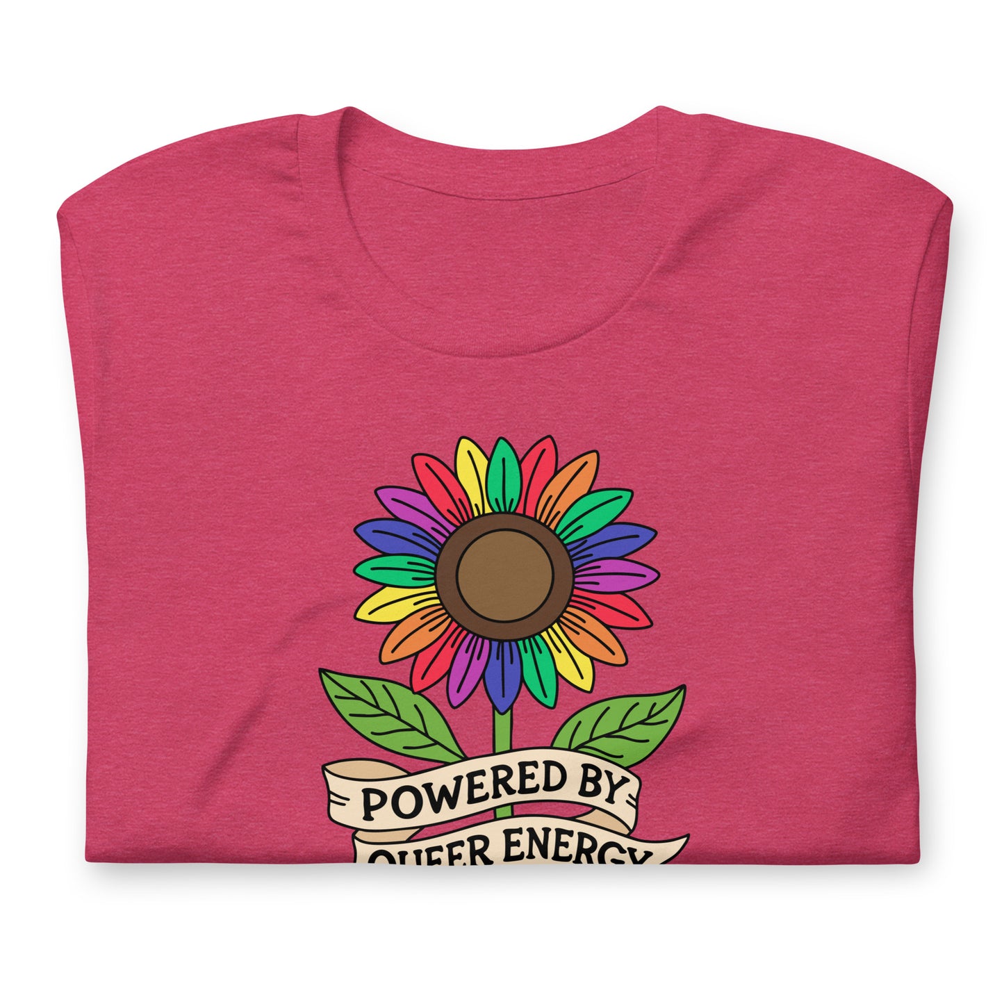 A folded heather pink t-shirt featuring a colorful rainbow sunflower graphic with green leaves and a banner that reads 'POWERED BY QUEER ENERGY'.