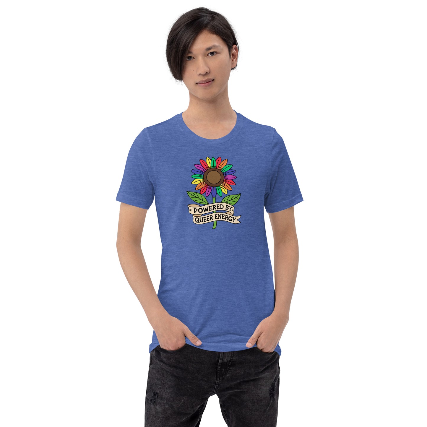 A model wearing a heather blue t-shirt with a colorful rainbow sunflower graphic and the text 'POWERED BY QUEER ENERGY' on the chest, paired with black jeans against a plain white background.