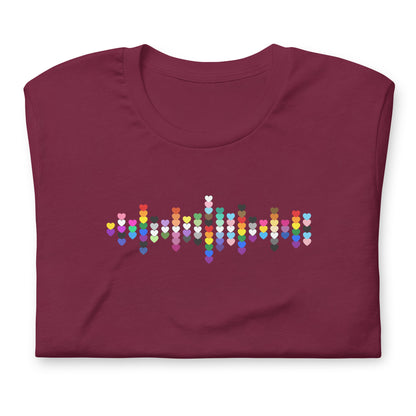 A flat lay folded maroon t-shirt with a Pride Heart graphic design across the chest.
