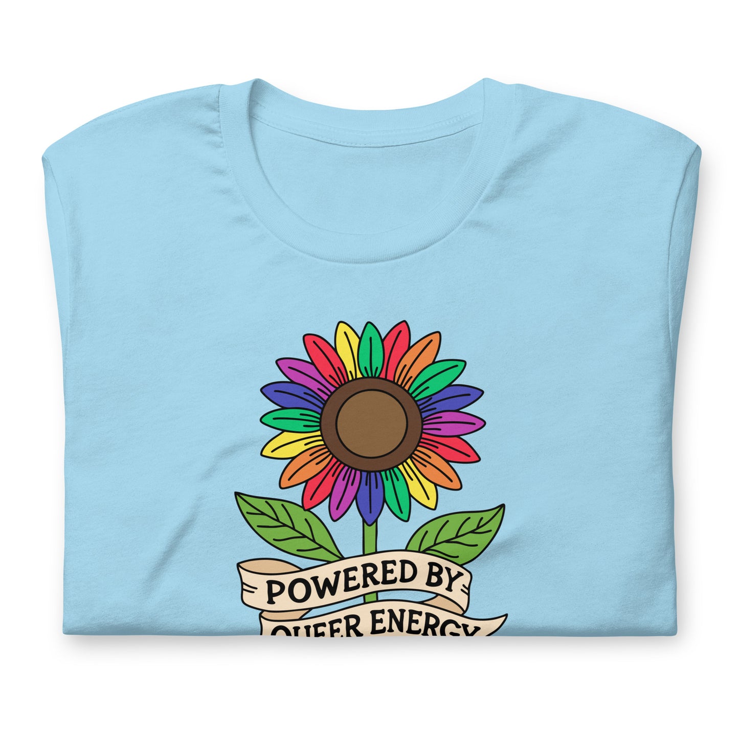 A light blue folded t-shirt featuring a colorful rainbow sunflower graphic with green leaves and a banner that reads 'POWERED BY QUEER ENERGY'.