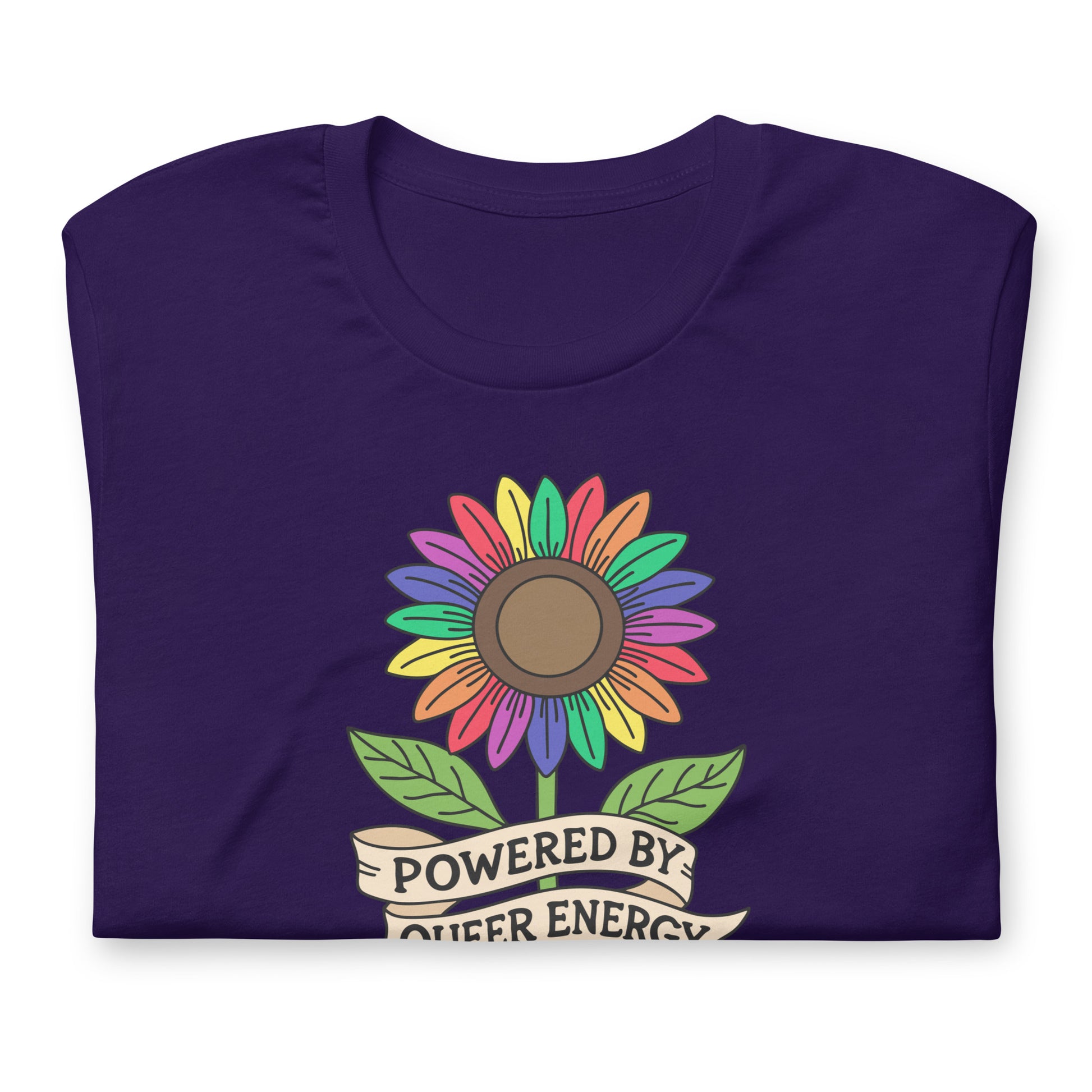 A folded dark purple t-shirt with a colorful rainbow sunflower graphic and a banner underneath that reads 'POWERED BY QUEER ENERGY'.
