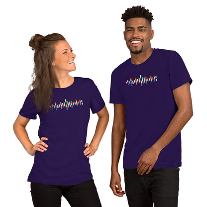 A smiling woman and man standing together, both wearing purple t-shirts with a colorful Pride hearts graphic on the chest.