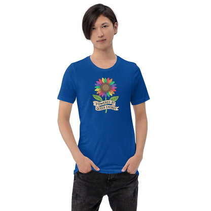 A model wearing a royal blue t-shirt with a colorful rainbow sunflower graphic and the text 'POWERED BY QUEER ENERGY' on the chest, paired with black jeans against a plain white background.