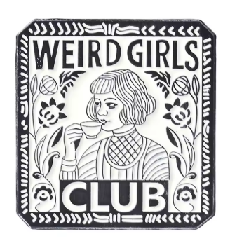 A square black and white enamel pin featuring an illustration of a woman drinking from a teacup, with the text 'WEIRD GIRLS CLUB' and decorative floral borders.