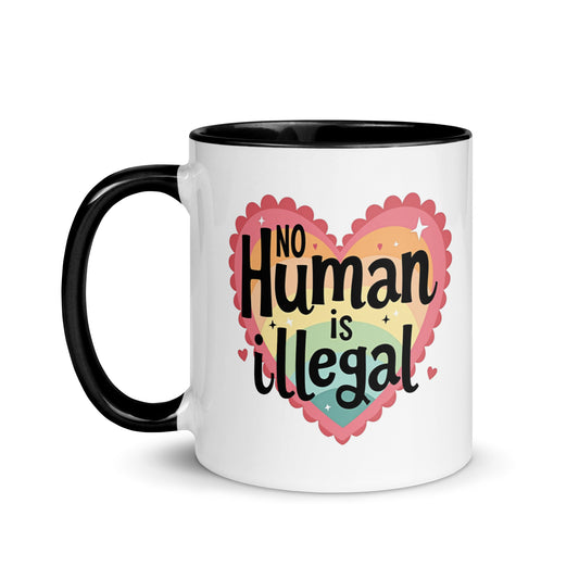 No Human is Illegal Rainbow Heart Accent Coffee Mug by Spinsterly Co, white ceramic with black rim